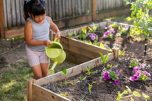 istock Child Watering Garden 2230020098