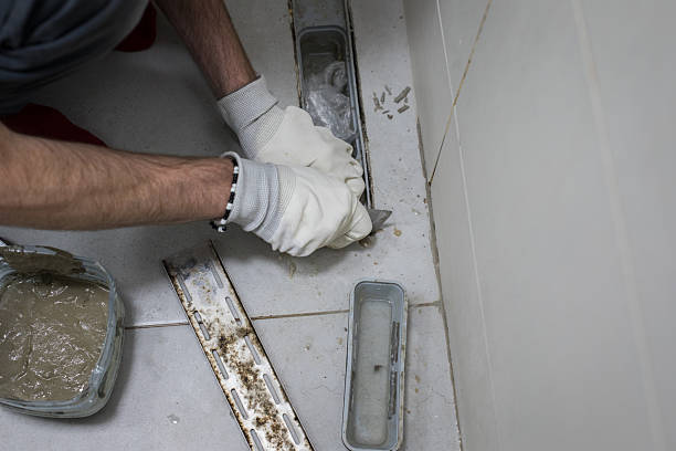 istock Bathroom drain on floor. Professional worker repairing sewer 2230021401
