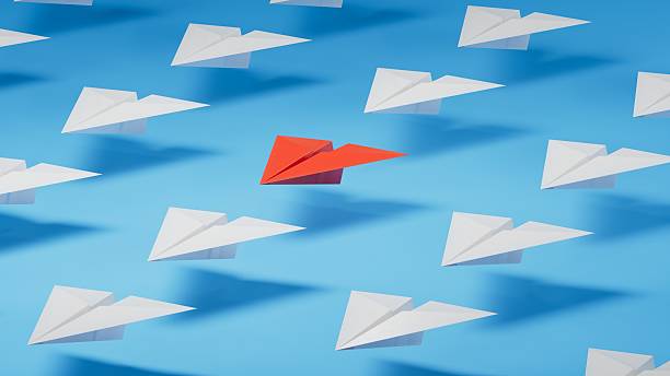 istock Different business concept.new ideas. paper art style. creative idea. red leader plane, standing out from the crowd of white planes.3D rendering on blue background. 2230021761