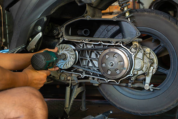 istock Mechanic’s hand performing maintenance on a scooter motorcycle’s CVT 2230027394