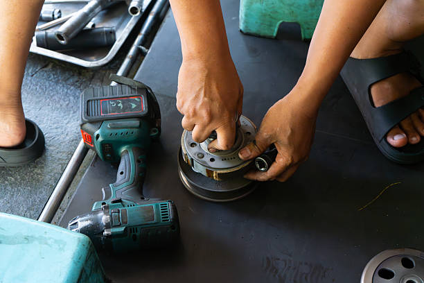 istock Mechanic’s hand performing maintenance on a scooter motorcycle’s CVT 2230027437
