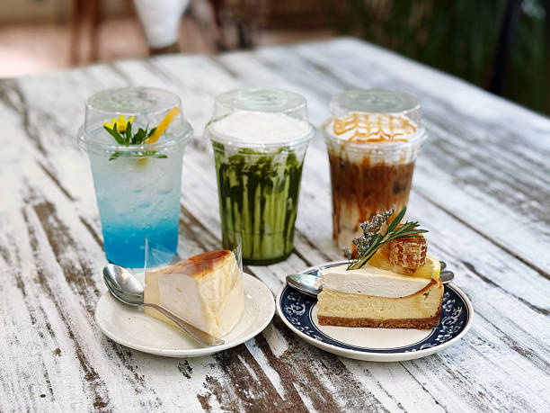 istock Ice coffee with cheesecake on wooden table. Top view, copy space 2230030633