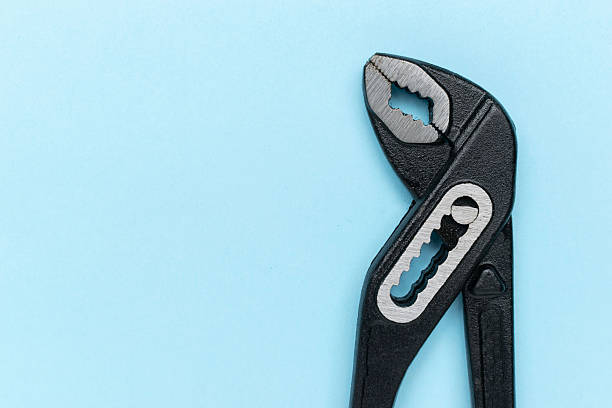 istock Adjustable Wrench on Light Blue Background: Simple Tools and Mechanics Concept 2230032769