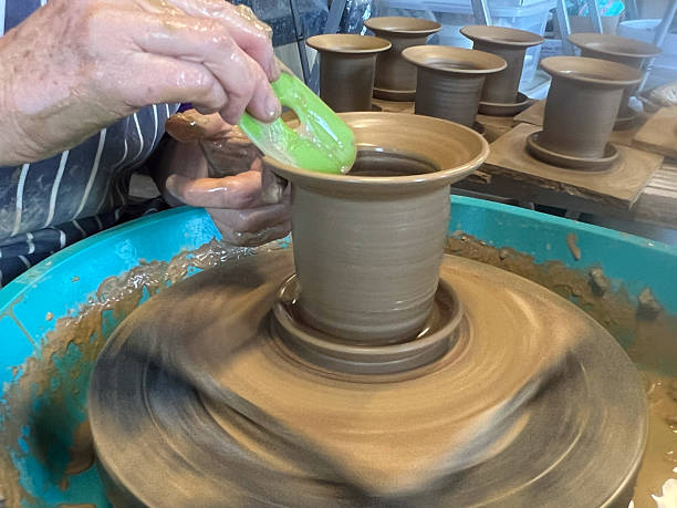 Woman hands creating and shaping clay on a pottery wheel