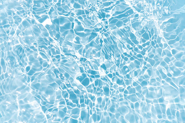 istock Blue water with ripples on the surface. Defocus blurred transparent blue colored clear calm water surface texture with splashes and bubbles. Water waves with shining pattern texture background. 2230041282