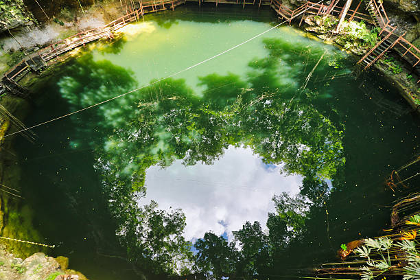 Scenic view of the green waters of the X'Canche Cenote, a  natural limestone cavern with a deep natural pool of fresh water near Ek Balam,near Valladolid,Yucatan,Mexico