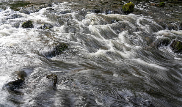 istock Flowing river water rushing over moss-covered rocks in a long exposure image, Blaenau Ffestiniog, Gwynedd, Wales, Britain 2230043199