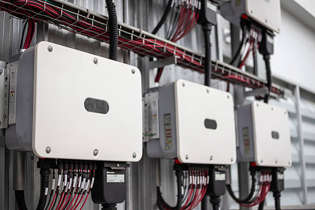 istock Inverter solar panel in electrical room. Service engineer installing solar cell on the roof of factory. Clean and Renewable energy concept. 2230043431