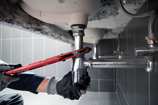 istock Technician plumber using a wrench to repair a water pipe under the sink. Concept of maintenance.specialist male plumber repairs faucet in bathroom. 2230043464