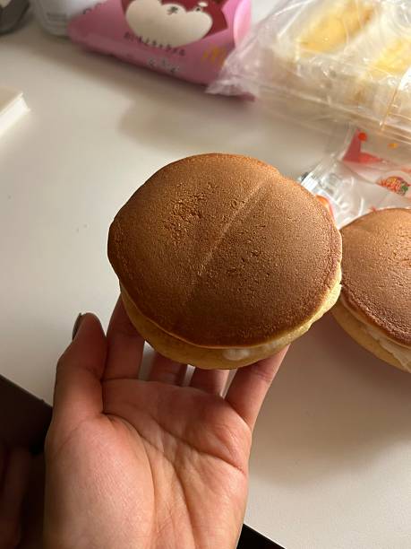 Soft and fluffy dorayaki pancakes filled with sweet red bean paste, creating a delicious Japanese treat perfect for snacking or dessert.
