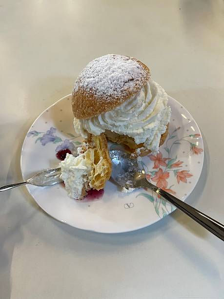 Light, airy cream puffs filled with luscious vanilla custard, dusted with powdered sugar. A delightful treat that melts in your mouth with each bite, perfect for any occasion.