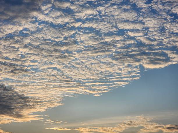 istock Soft White Clouds in a Blue Sky at Sunset 2230051625