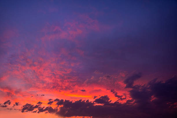 Colorful clouds during sunset during an autumn afternoon. Some of the clouds are illuminated by the last rays of sunlight.