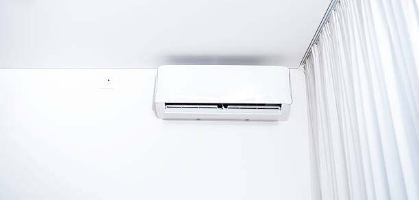 istock Wall-mounted inverter air conditioner or white split system on white wall 2230052594
