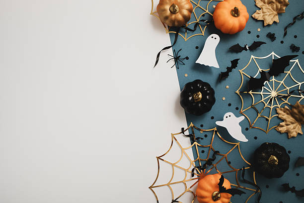 istock Halloween party border from pumpkins, bats, spider web, ghosts on dark blue background top view. 2230052822