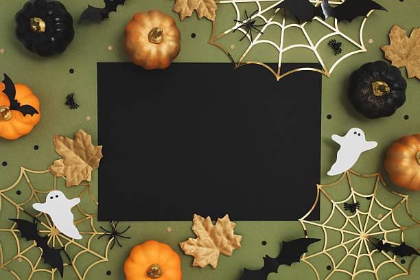 istock Halloween party composition with empty black card with festive decoration from pumpkins, bats, spider web, ghosts on green background top view. 2230052901