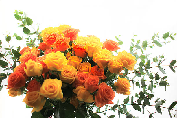 Yellow and orange roses and eucalyptus bouquet