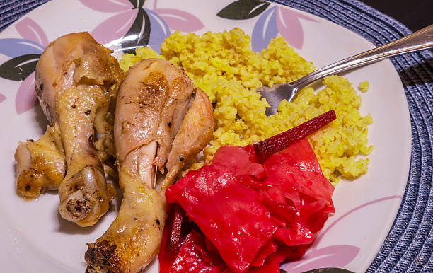 istock Enjoying roasted chicken drumsticks with millet and pickled cabbage 2230057999