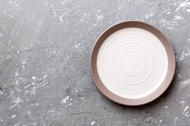istock Top view of empty light plate on cement background. Empty space for your design 2230059235