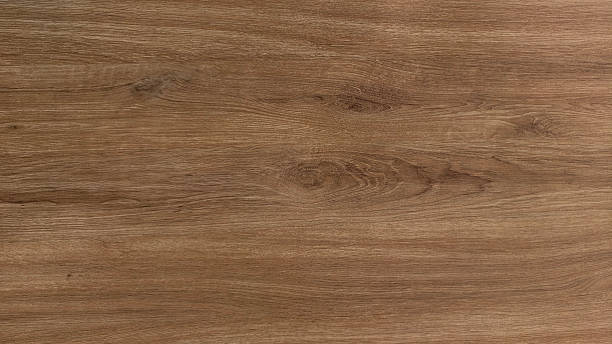 istock Artificial wood surface with natural light brown wood grain texture. Grain runs horizontally with distinct, darker lines and knots giving it realistic and rustic appearance. texture combination smooth 2230060772