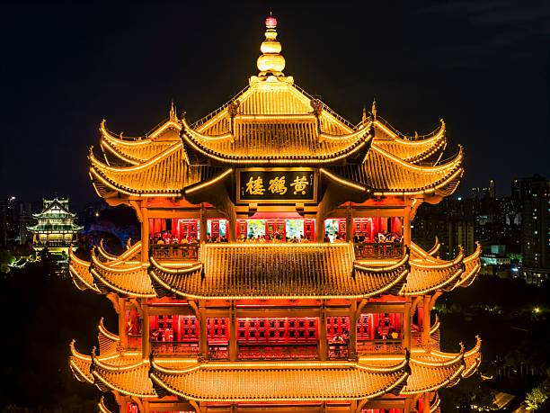 Ancient Chinese temple and pagoda hidden deep in a lush green forest, showcasing traditional architectural style and cultural charm, surrounded by trees and natural tranquility, symbolizing peace and spirituality.
