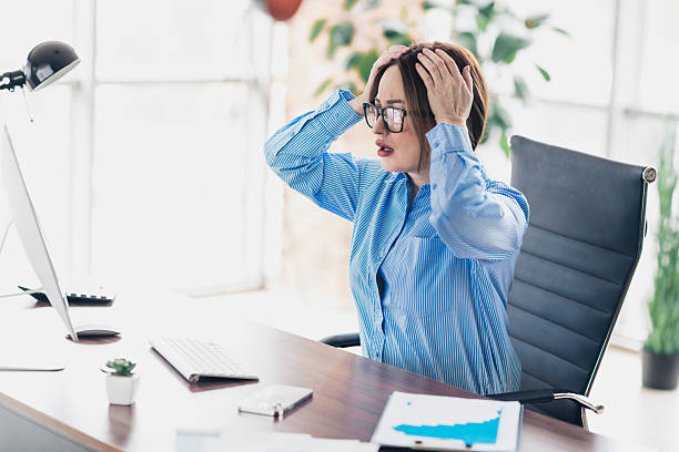 istock Woman specialist reacting with shock while working in an office setting with a computer and documents 2230063187