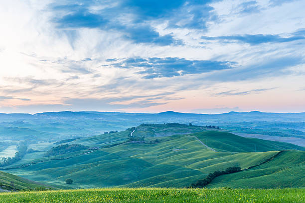 istock Hills and fields in a hilly landscape at sunrise 2230063621