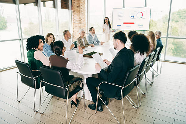 istock Business professionals discussing reports and data during an office team meeting in a modern collaborative workspace. 2230065359