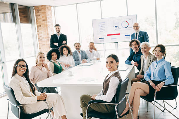 istock Diverse group of professionals collaborating during a business presentation in a modern office conference room 2230065402
