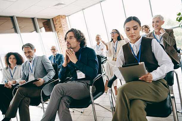 istock Group of professionals engaged in a collaborative business training session in a modern coworking space with natural light 2230065451