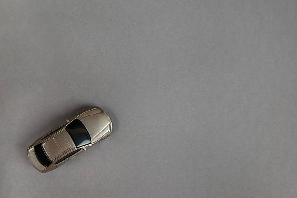 Close-up of plastic ride-on toy car for toddlers placed on indoor tiled floor with modern interior background.