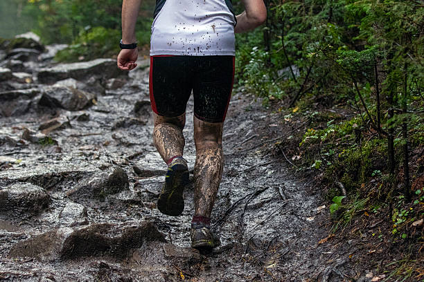 istock Man athlete running muddy stones trail during forest marathon 2230068333