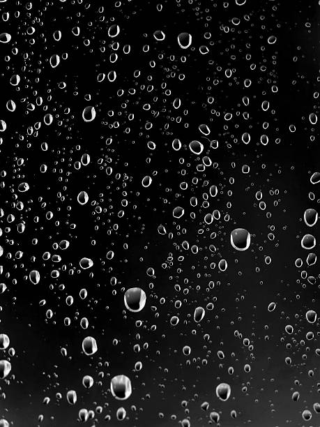 istock Raindrops on a window glass during a rainstorm at night 2230073908
