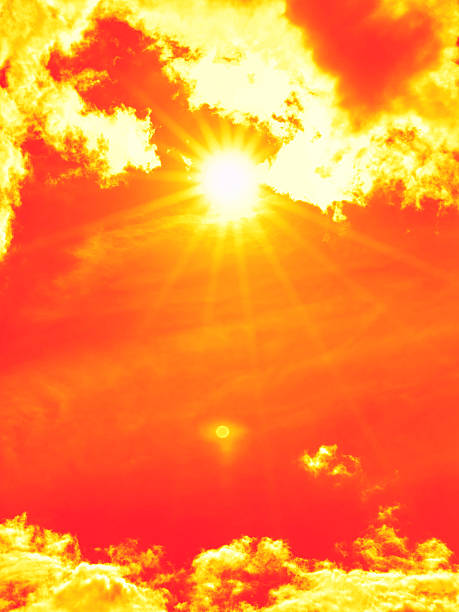 istock Bright sun with beautiful beams in the sky with clouds (toned in red) 2230074195