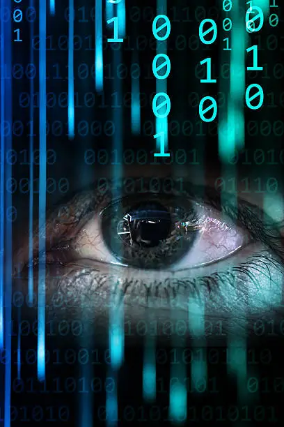 Photo of Binary code streams flowing across an eye representing data processing and technology in a digital environment