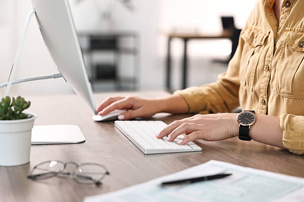 istock Woman working on computer at table in office, closeup 2230075517