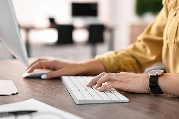 istock Woman working on computer at table in office, closeup 2230075687