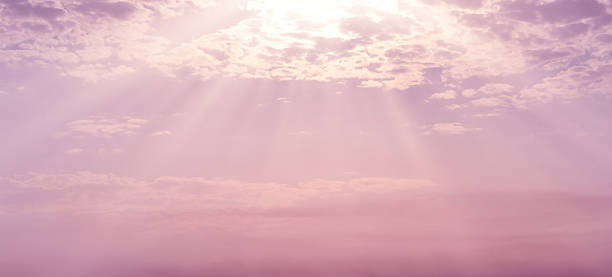 istock Purple pink golden sky with cloud. Sunlight shining through the clouds. 2230076044