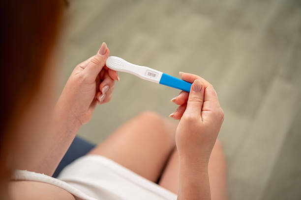 istock A woman holds a pregnancy test with two stripes in her hands 2230077487