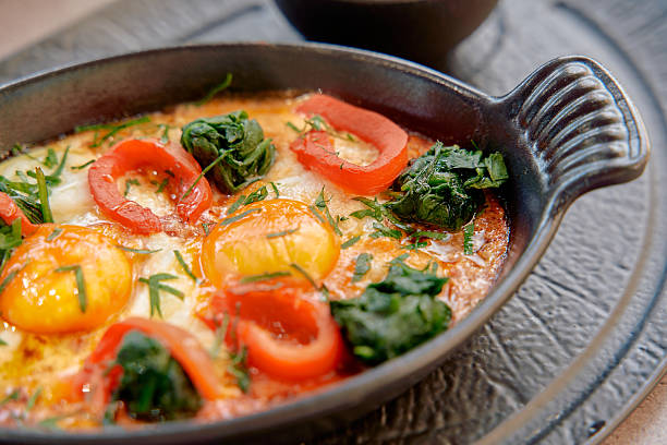 istock A Vibrant Dish of Eggs Baked with Fresh Vegetables and Herbs, Served in a Rustic Pan for a Flavorful Culinary Experience 2230078113