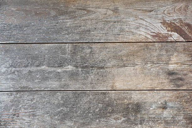 istock Three horizontal wooden boards worn by time brown and gray 2230082120