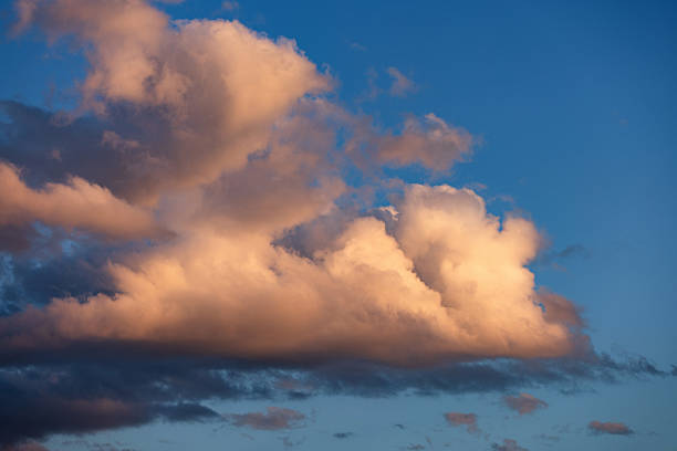istock A large textured yellow cloud against a blue sky captured in the afternoon light. 2230085574
