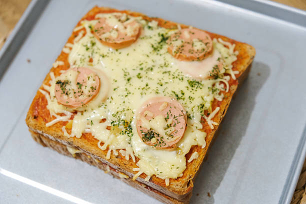 istock Homemade pizza made from white bread with sausage and cheese toppings 2230086659