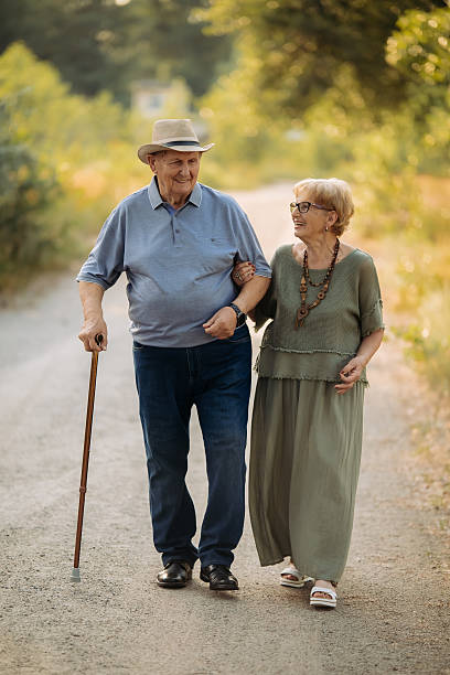 Senior woman and caregiver go walking outdoors