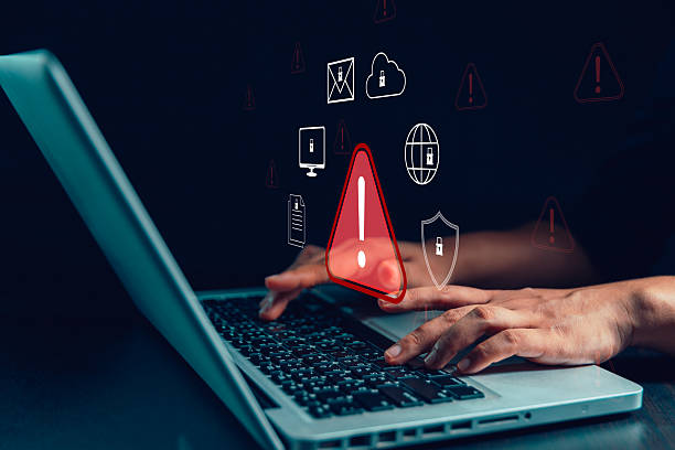istock Businesswoman receives cyber security warning alert on smartphone and computer, data vulnerability, compromised information illegal, concept of digital threat protection. system detects network hack 2230087993