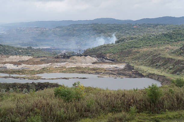 istock Excavators working in Kolubara open pit coal mine polluting the environment in Serbia 2230088728