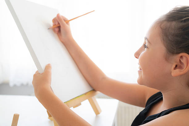 istock Little artist with pencil sketching on canvas 2230090404