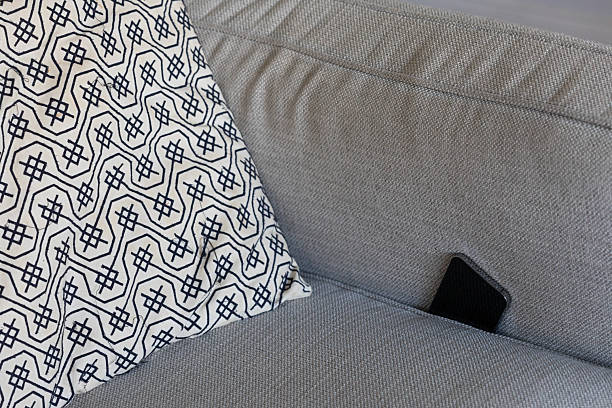 istock Mobile phone lost in sofa cushions 2230090456