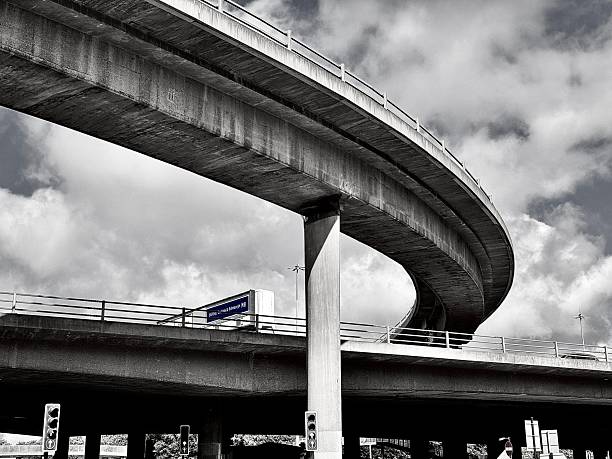 Low angle view of a curved road intersection against cloudscape in Glasgow