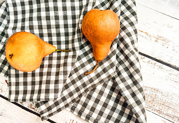 Bosc Pears And Black & White Checked Tea Towel On Wood